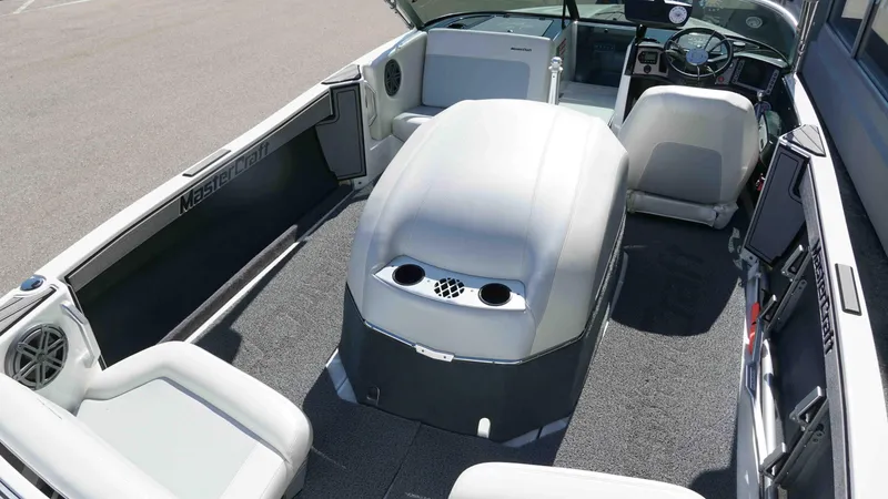 Slide: The Image of 2017 MasterCraft ProStar interior with seating, steering wheel, and carpeted flooring. - 2