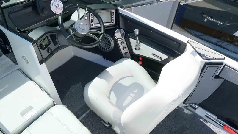 Slide: The Image of 2017 MasterCraft ProStar boat interior with steering wheel, dashboard, and white seating. - 5