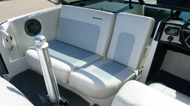 Slide: The Image of 2017 MasterCraft ProStar interior with white seating and dashboard controls. - 7