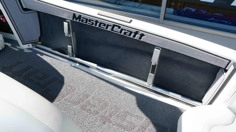 Slide: The Image of 2017 MasterCraft ProStar interior with branded storage compartment and carpeted flooring. - 9