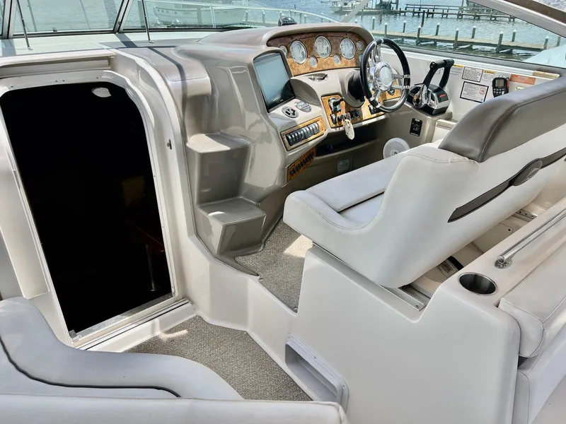 Slide: The Image of 2007 Rinker 350 Express Cruiser cockpit with steering wheel and control panel. - 12