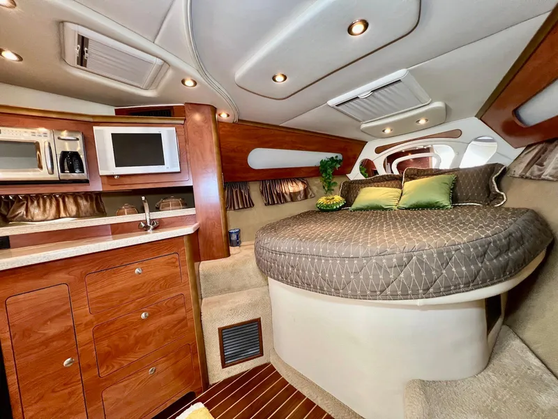 Slide: The Image of Interior of 2007 Rinker 350 Express Cruiser with kitchenette and cozy sleeping area. - 19