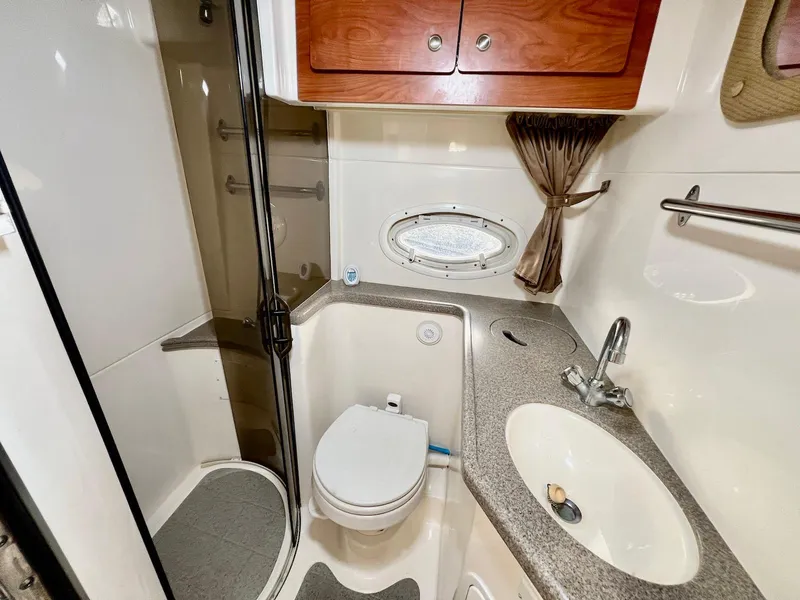 Slide: The Image of 2007 Rinker 350 Express Cruiser bathroom with shower, sink, and toilet. - 29
