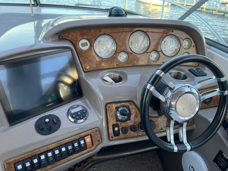 Slide: The Image of 2007 Rinker 350 Express Cruiser dashboard with steering wheel and navigation controls. - 7