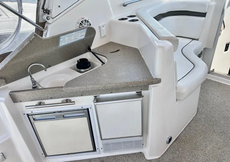 Slide: The Image of 2007 Rinker 350 Express Cruiser interior with kitchenette and seating area. - 8