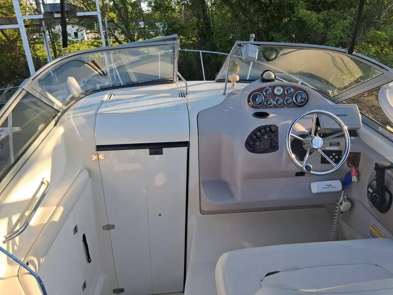 Slide: The Image of 1999 Regal Commodore 242 boat cockpit with steering wheel and control panel. - 4