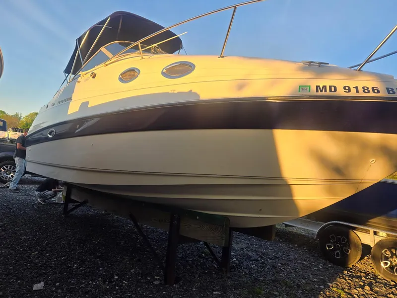 Slide: The Image of 1999 Regal Commodore 242 boat on trailer, side view, with blue canopy. - 5