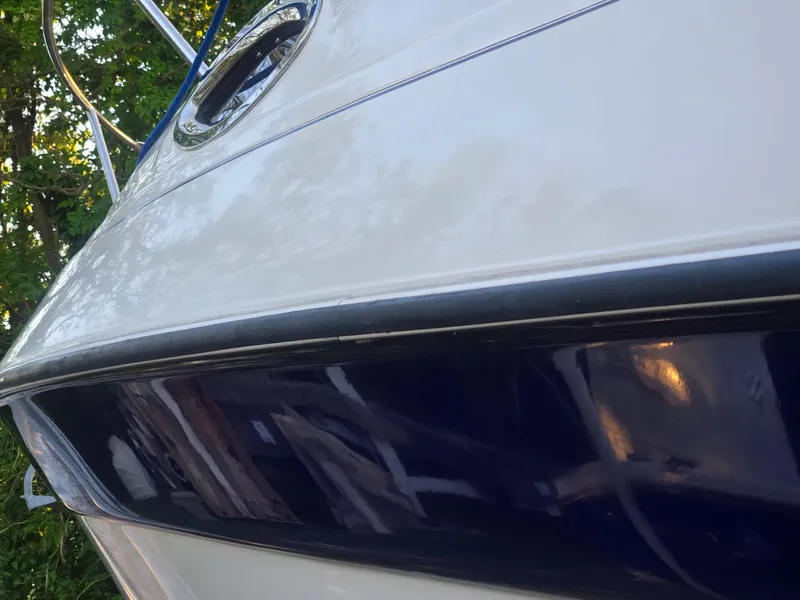 Slide: The Image of 1999 Regal Commodore 242 boat, close-up view of hull and porthole. - 7