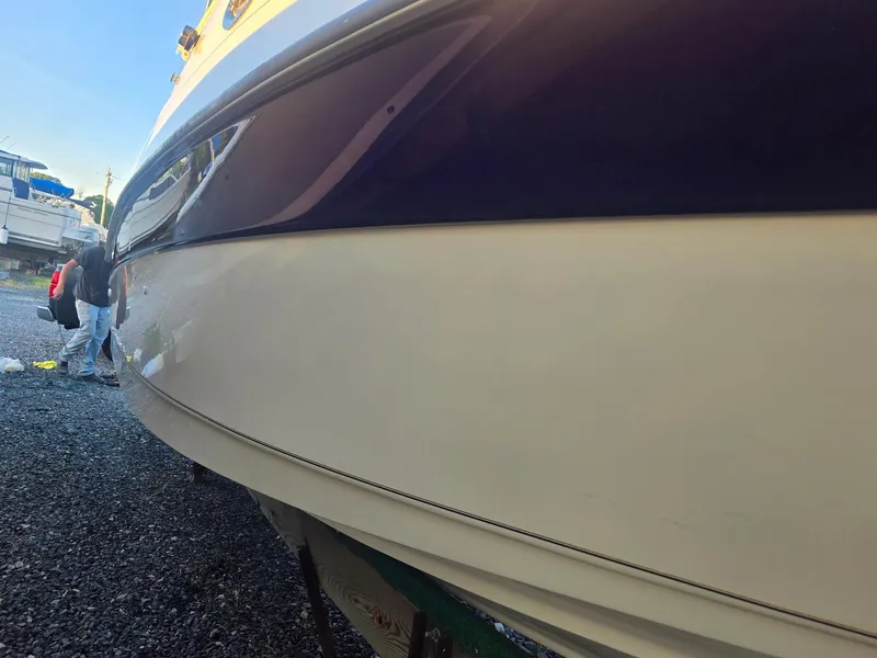 Slide: The Image of 1999 Regal Commodore 242 boat on gravel, side view. - 9