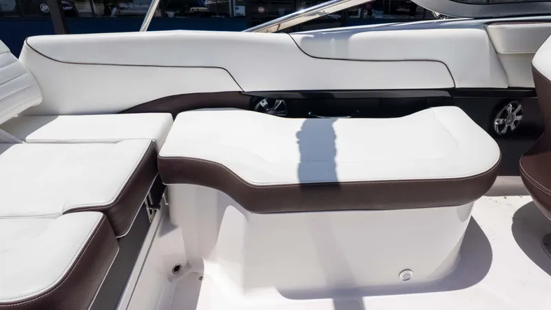 Slide: The Image of 2016 Regal 2300 boat interior with white and brown seating. - 11