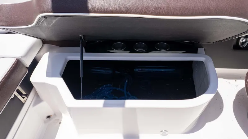 Slide: The Image of 2016 Regal 2300 boat storage compartment with open lid, showcasing interior space. - 12