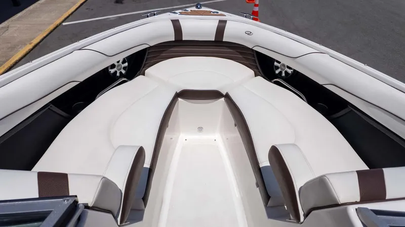Slide: The Image of 2016 Regal 2300 boat interior with white and brown seating, showcasing spacious design. - 15