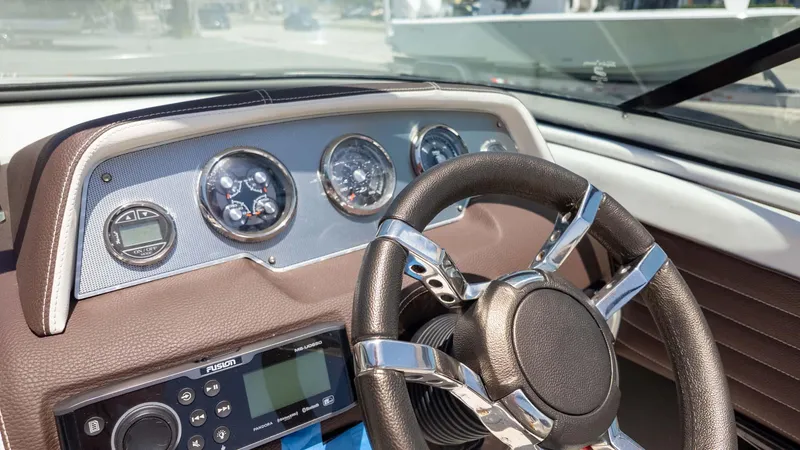 Slide: The Image of Dashboard of a 2016 Regal 2300 boat with steering wheel and gauges. - 18