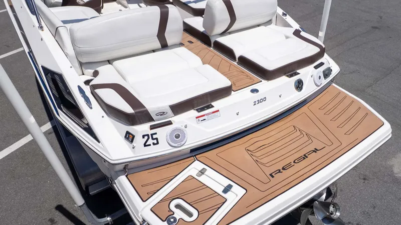 Slide: The Image of 2016 Regal 2300 boat with white and brown seating, teak-style swim platform. - 4