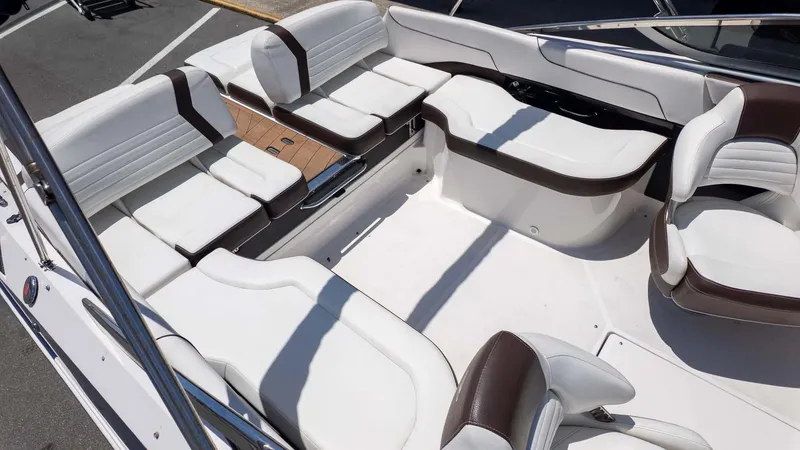 Slide: The Image of 2016 Regal 2300 boat interior with white and brown seating, spacious layout. - 6
