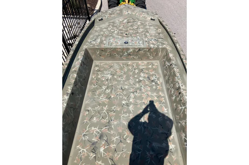 Slide: The Image of 2025 Tracker Grizzly 1754 Jon boat with camouflage pattern on deck. - 4