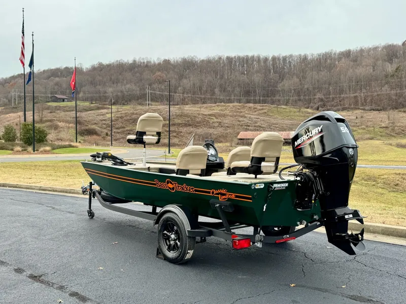 Slide: The Image of 2025 Tracker Bass Tracker Classic Limited boat on trailer, parked outdoors. - 2