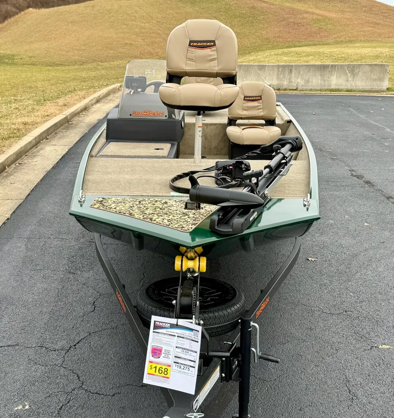 Slide: The Image of 2025 Tracker Bass Tracker Classic Limited fishing boat on display in a parking lot. - 6