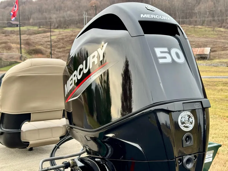 Slide: The Image of 2025 Tracker Bass Tracker Classic Limited with Mercury 50 outboard motor in scenic outdoor setting. - 7