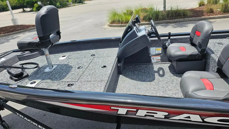 Slide: The Image of 2025 Tracker Pro Team 175 Crappie Edition boat interior with seating and steering console. - 10