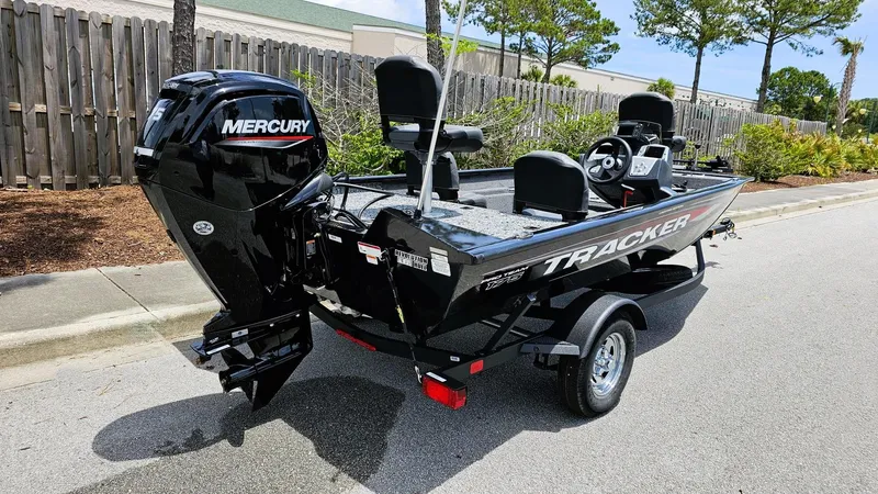 Slide: The Image of 2025 Tracker Pro Team 175 Crappie Edition boat with Mercury engine on a trailer. - 2