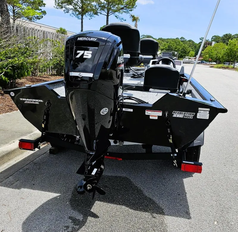 Slide: The Image of 2025 Tracker Pro Team 175 Crappie Edition boat with Mercury 75 engine, parked outdoors. - 4