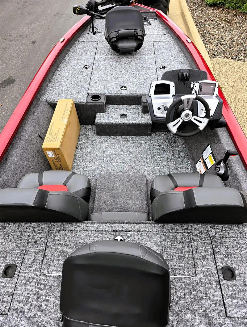 Slide: The Image of 2025 Tracker Pro Team 190 boat interior with modern steering console and seating. - 2