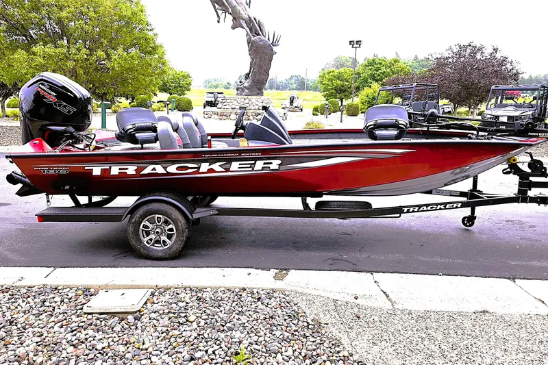 Slide: The Image of 2025 Tracker Pro Team 190 boat on trailer, parked outdoors. - 4
