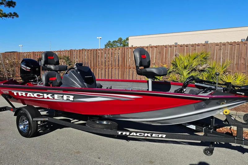 Slide: The Image of 2025 Tracker Pro Team 175 Crappie Edition boat dashboard with steering wheel and electronic displays. - 5