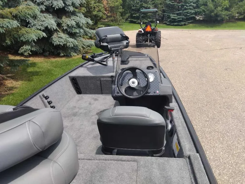 Slide: The Image of 2025 Tracker Bass Tracker Classic XL boat interior with steering wheel and seating. - 7