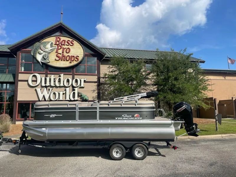 Slide: The Image of 2025 Sun Tracker Party Barge 20 DLX pontoon boat outside Bass Pro Shops Outdoor World. - 5