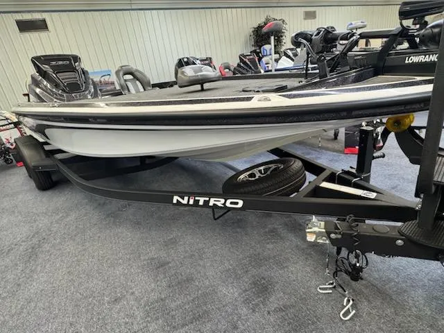 Slide: The Image of 2024 Nitro Z20 Pro boat on display with trailer in showroom. - 1