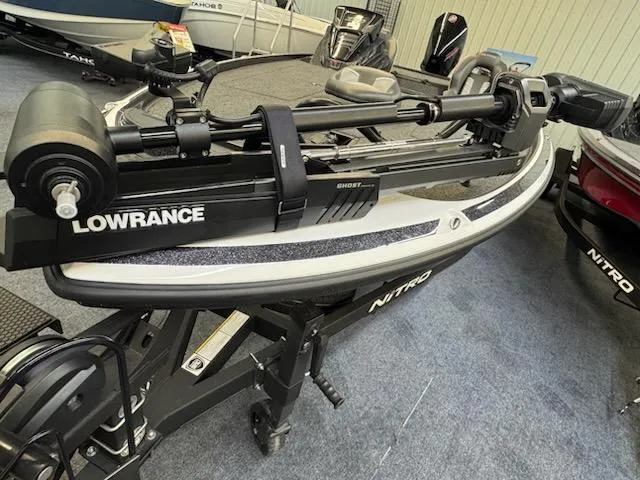 Slide: The Image of 2024 Nitro Z20 Pro boat with Lowrance Ghost trolling motor in showroom. - 2