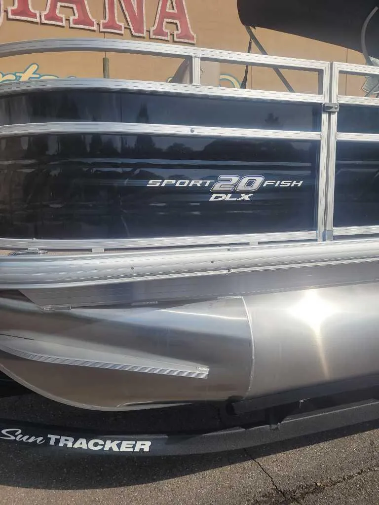 Slide: The Image of 2025 Sun Tracker SportFish 20 DLX pontoon boat, side view with branding visible. - 4