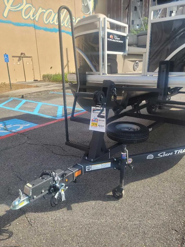Slide: The Image of 2025 Sun Tracker SportFish 20 DLX pontoon boat on trailer in parking lot. - 5