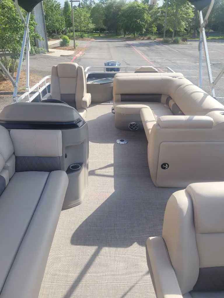 Slide: The Image of 2025 Sun Tracker SportFish 20 DLX pontoon boat with spacious seating and modern design. - 6