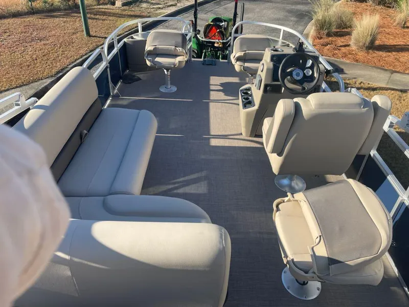 Slide: The Image of 2025 Sun Tracker Bass Buggy 18 DLX pontoon boat interior with seating and steering console. - 3