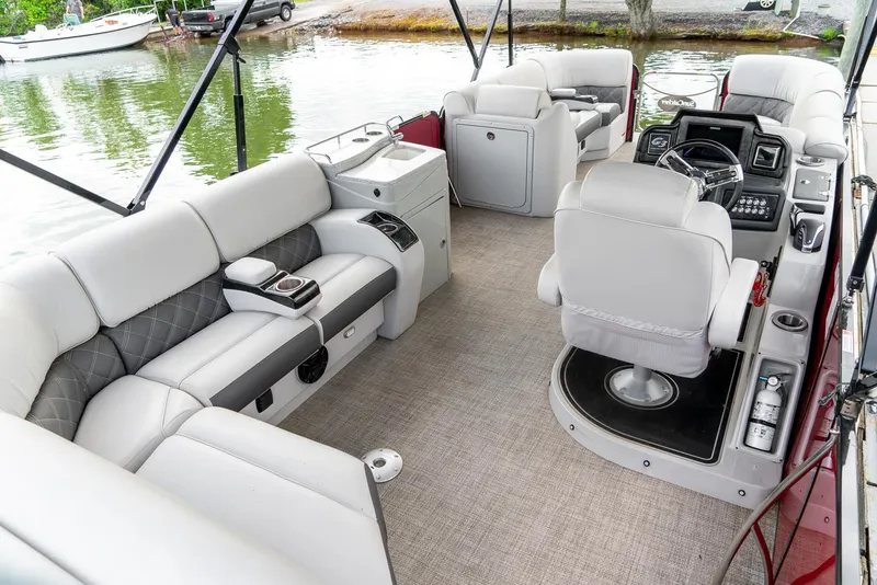 Slide: The Image of 2021 G3 SunCatcher Elite 326 Cruise pontoon boat interior with plush seating and modern controls. - 10