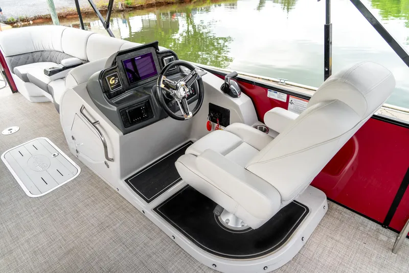Slide: The Image of 2021 G3 SunCatcher Elite 326 Cruise boat interior with helm, steering wheel, and seating. - 12