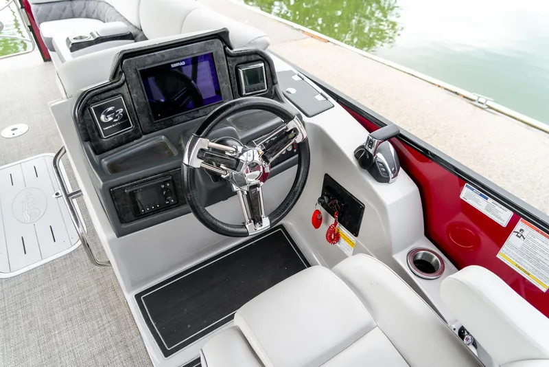 Slide: The Image of 2021 G3 SunCatcher Elite 326 Cruise boat dashboard with steering wheel and controls. - 13