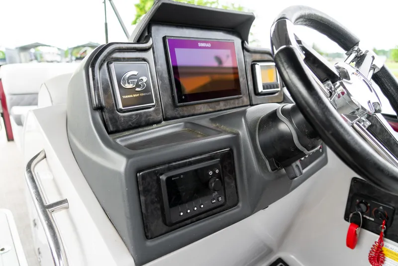 Slide: The Image of 2021 G3 SunCatcher Elite 326 Cruise dashboard with steering wheel and digital display. - 14