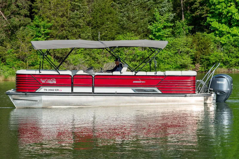 Slide: The Image of 2021 G3 SunCatcher Elite 326 Cruise pontoon boat on a serene lake. - 2