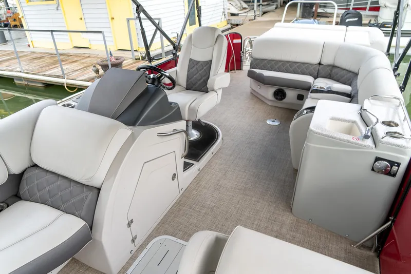 Slide: The Image of 2021 G3 SunCatcher Elite 326 Cruise interior with plush seating and modern helm. - 21