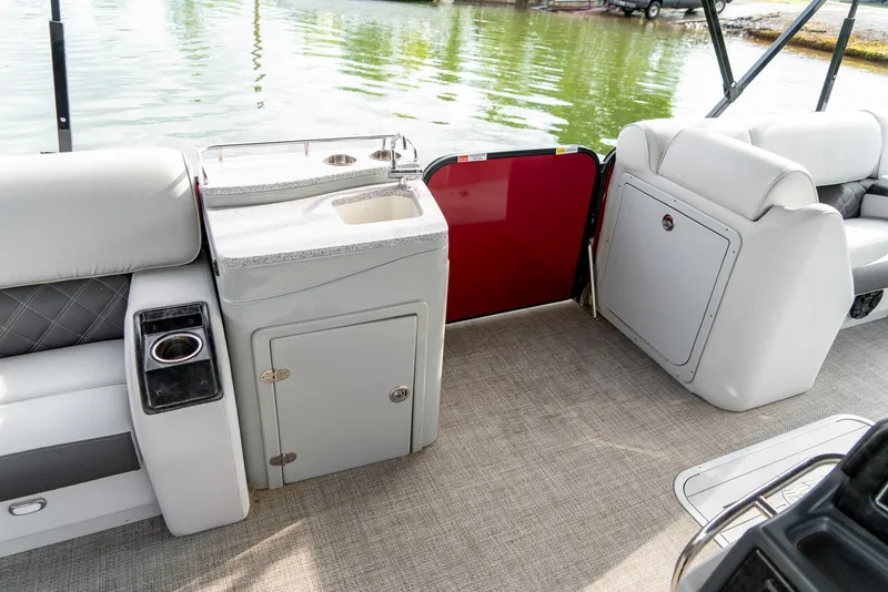 Slide: The Image of 2021 G3 SunCatcher Elite 326 Cruise interior with seating, storage, and water view. - 26
