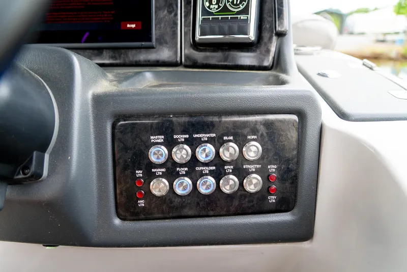 Slide: The Image of Control panel of 2021 G3 SunCatcher Elite 326 Cruise boat with labeled switches and buttons. - 29