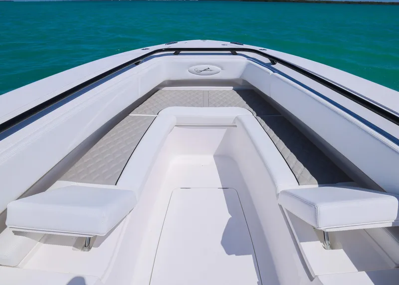 Slide: The Image of 2025 Blackwater 43 Sportfish boat interior with white seating and turquoise water backdrop. - 11