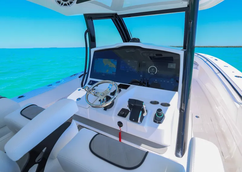 Slide: The Image of 2025 Blackwater 43 Sportfish boat cockpit with modern controls on turquoise water. - 20