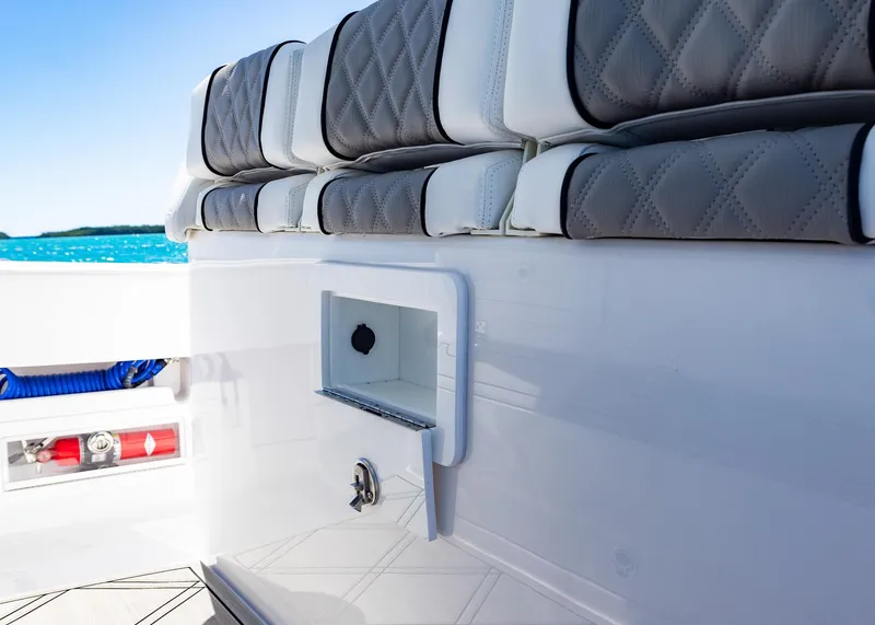 Slide: The Image of 2025 Blackwater 43 Sportfish boat interior with cushioned seating and storage compartment. - 27