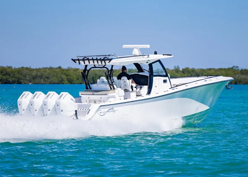 Slide: The Image of 2025 Blackwater 43 Sportfish boat cruising on clear blue water. - 3