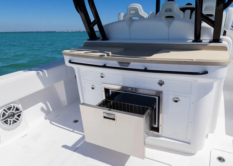 Slide: The Image of 2025 Blackwater 43 Sportfish boat with open storage drawer, sleek design, and ocean backdrop. - 31
